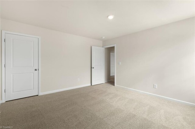 empty room featuring light carpet