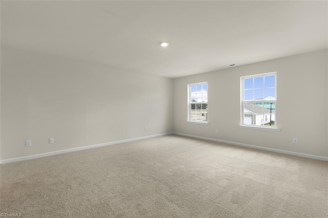 spare room featuring light colored carpet