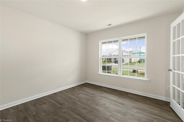 unfurnished room with dark hardwood / wood-style floors