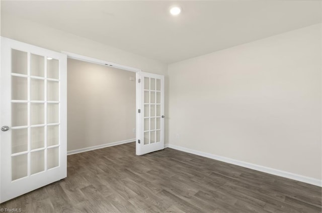 empty room featuring dark hardwood / wood-style floors and french doors