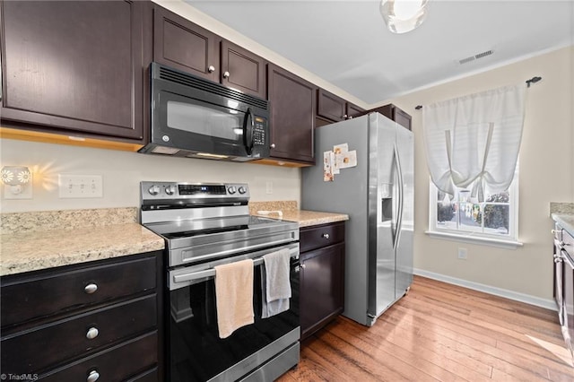 kitchen featuring light countertops, visible vents, light wood-style flooring, appliances with stainless steel finishes, and dark brown cabinetry