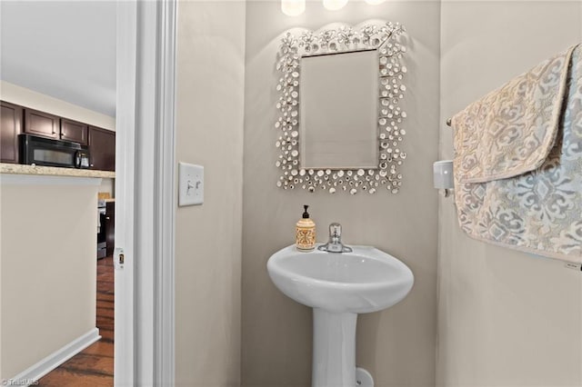 bathroom featuring baseboards and wood finished floors