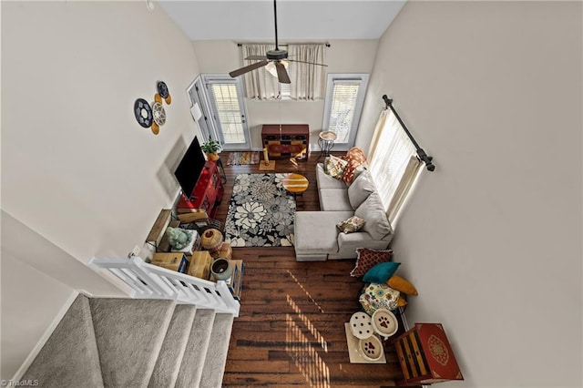 living area with ceiling fan, baseboards, and wood finished floors