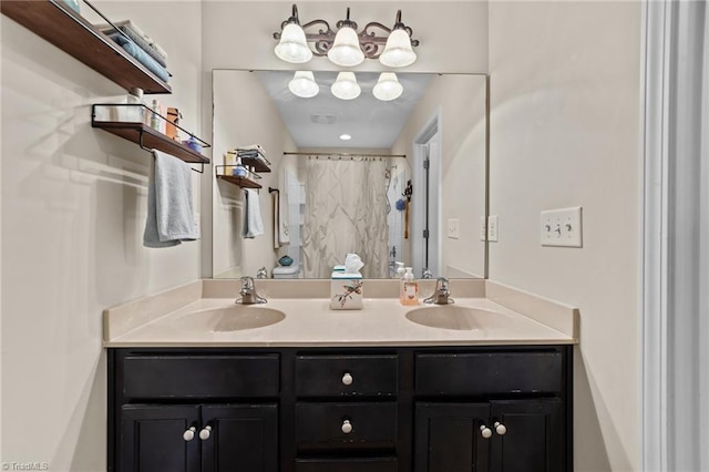 bathroom featuring double vanity, a shower with shower curtain, and a sink