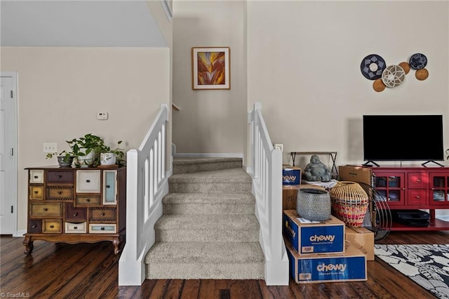 stairway with baseboards and wood finished floors