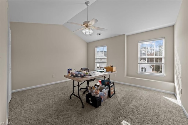 carpeted office space featuring lofted ceiling, visible vents, a ceiling fan, and baseboards