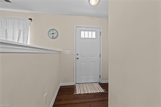 doorway with baseboards and wood finished floors