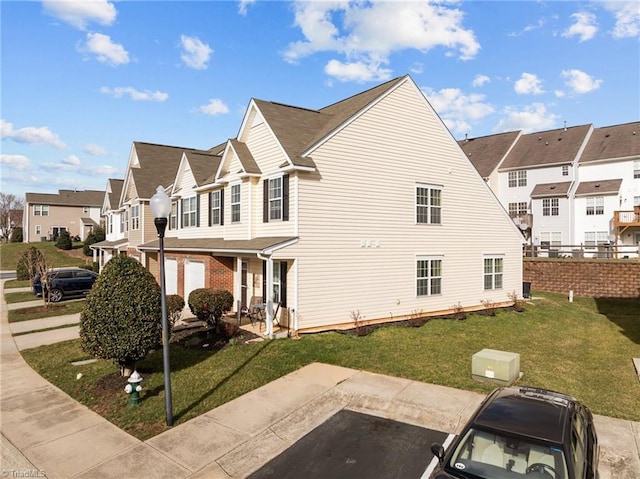 view of home's exterior with a residential view and a lawn