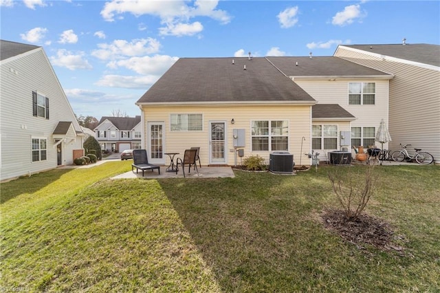 back of house with a yard, a patio area, and central air condition unit