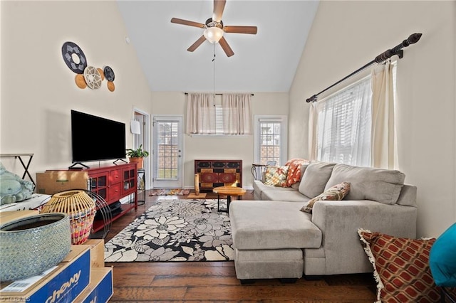 living area featuring high vaulted ceiling, wood finished floors, and a ceiling fan