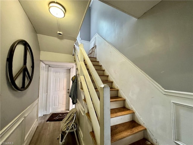 staircase featuring wood-type flooring