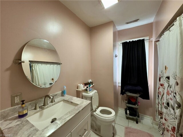 bathroom with tile patterned floors, vanity, and toilet