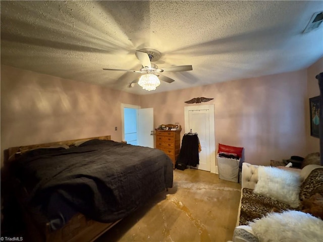 bedroom with ceiling fan and a textured ceiling