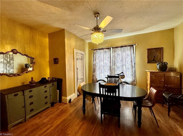 dining room featuring ceiling fan, wood-type flooring, and a textured ceiling