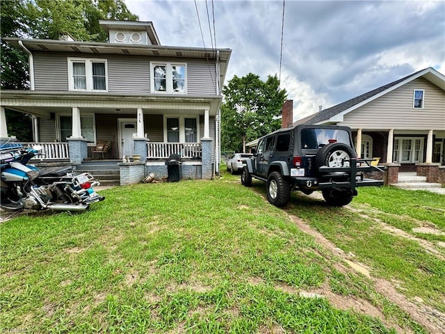 view of front of property with a porch and a front lawn