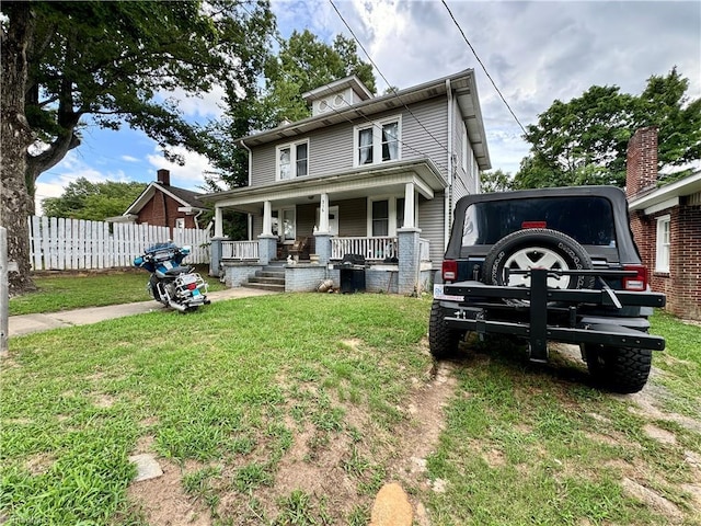 view of front of home with a porch and a front yard