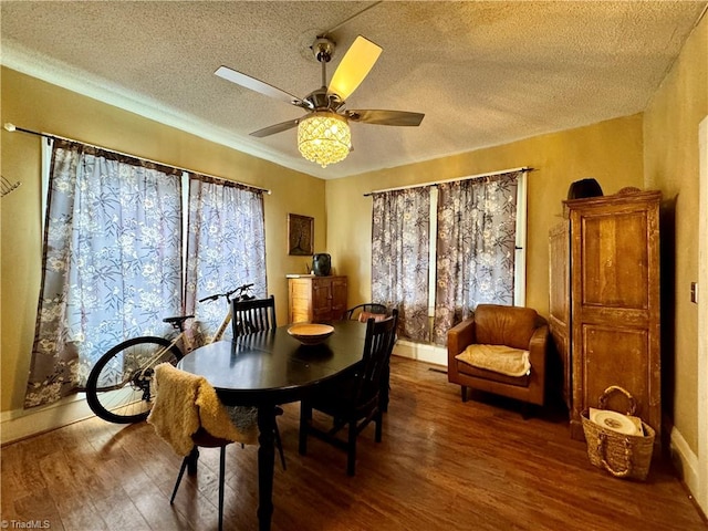 dining area featuring a textured ceiling, ceiling fan, and wood-type flooring