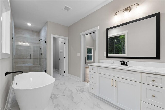 bathroom with independent shower and bath and vanity