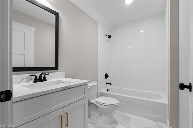 full bathroom with tiled shower / bath, vanity, and toilet