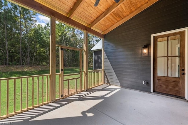 unfurnished sunroom featuring vaulted ceiling with beams and wood ceiling