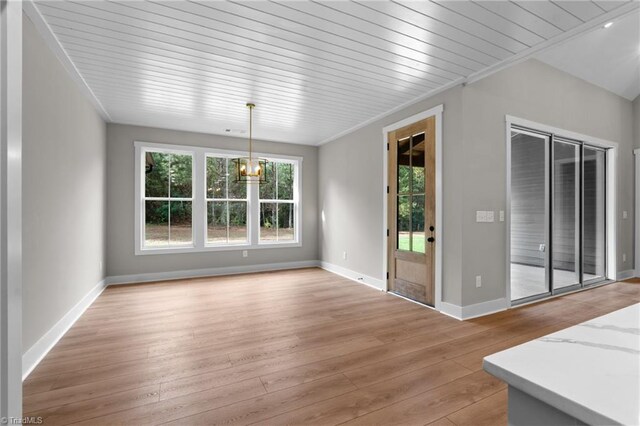 unfurnished dining area with crown molding, light hardwood / wood-style flooring, and wooden ceiling