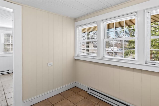 tiled empty room with a baseboard radiator