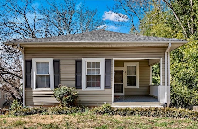 view of front of house with a porch and roof with shingles