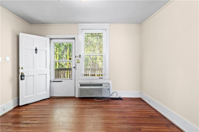 doorway featuring a wall mounted AC, wood finished floors, and baseboards