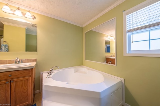 bathroom with vanity, a tub, ornamental molding, and a textured ceiling