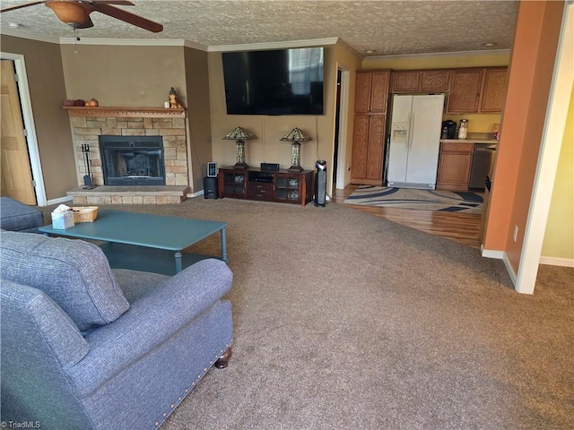 living room featuring a fireplace, ornamental molding, a textured ceiling, and carpet