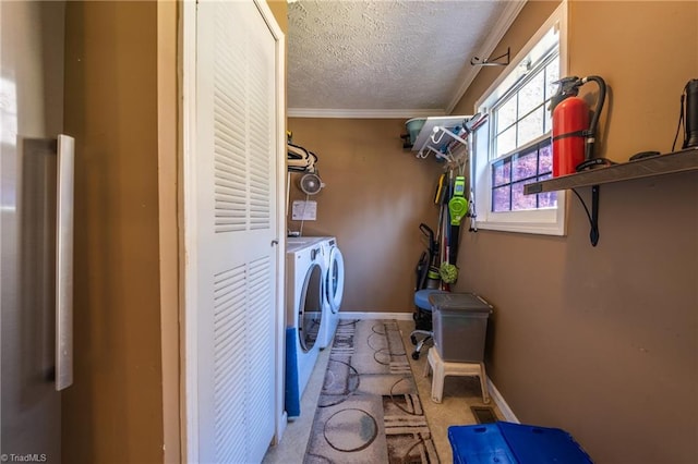 clothes washing area with light carpet, crown molding, independent washer and dryer, and a textured ceiling