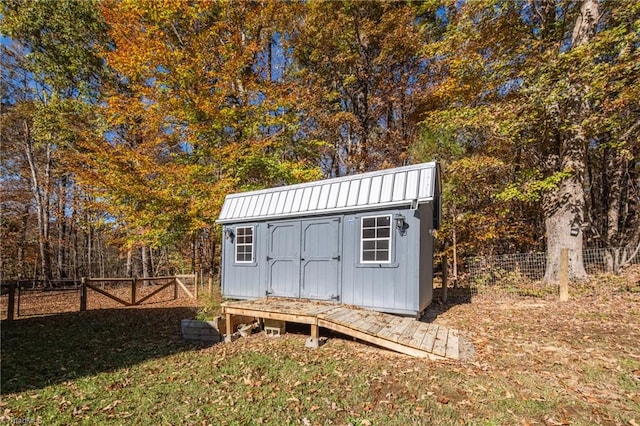 view of outbuilding with a yard