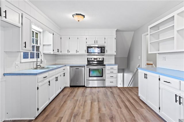 kitchen with appliances with stainless steel finishes, sink, and white cabinets