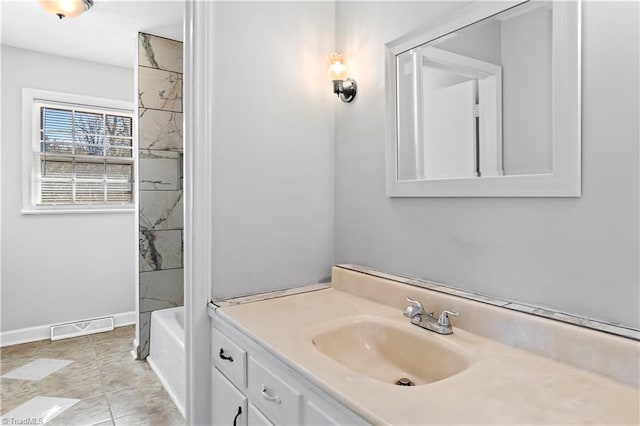 bathroom with vanity and tiled shower / bath combo