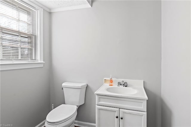 bathroom featuring vanity, crown molding, a textured ceiling, and toilet