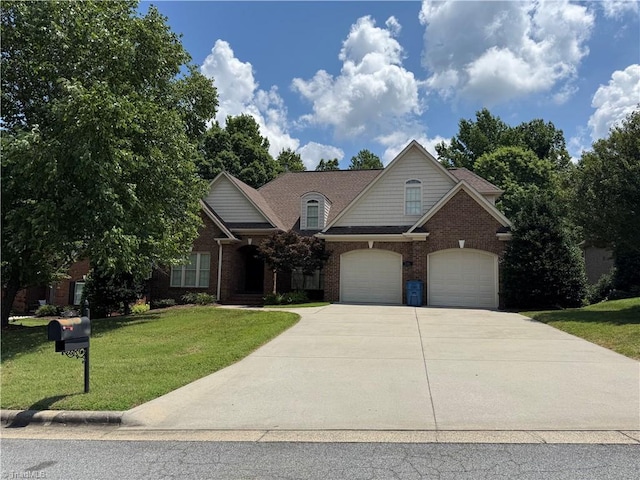 1206 Byron Ln, Archdale, NC 27263 - traditional-style house featuring driveway, a front lawn, and brick siding