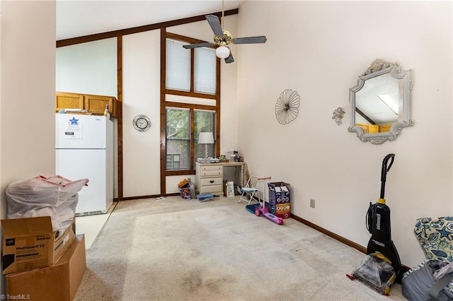 miscellaneous room with high vaulted ceiling, ceiling fan, and light carpet