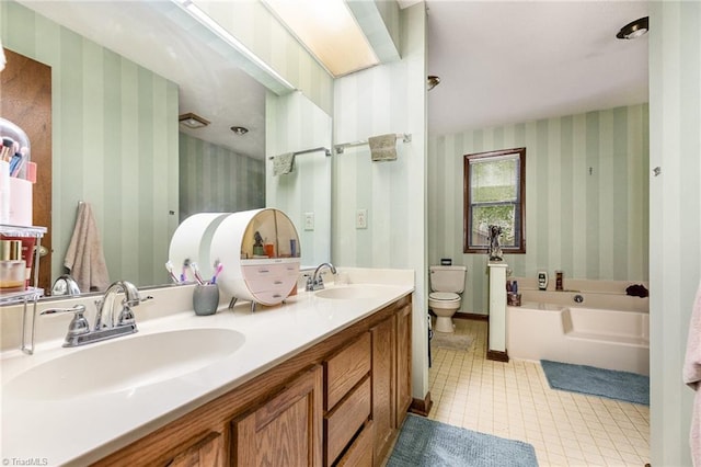 bathroom featuring a tub, toilet, vanity, and tile patterned floors