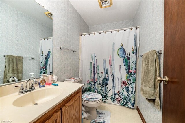 bathroom with vanity, toilet, and a shower with shower curtain