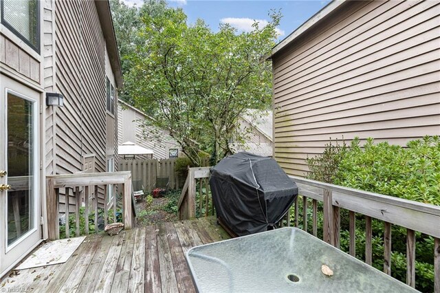 wooden terrace featuring grilling area