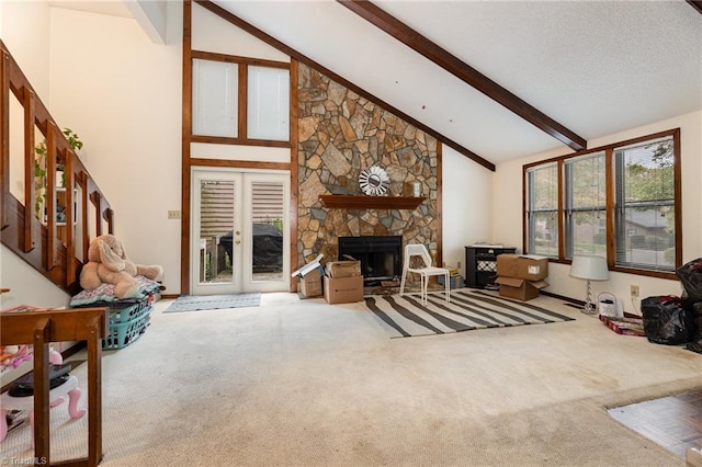 living room with carpet floors, a fireplace, beamed ceiling, and high vaulted ceiling