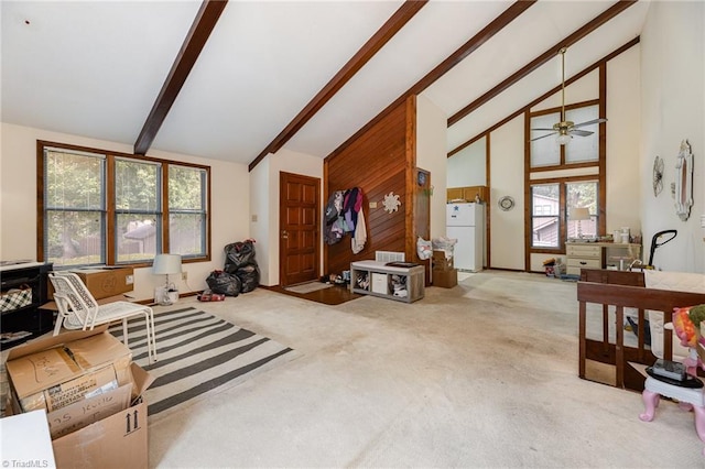 carpeted living room featuring high vaulted ceiling, a wealth of natural light, ceiling fan, and beamed ceiling