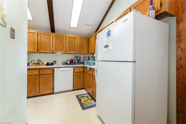 kitchen featuring lofted ceiling with beams and white appliances