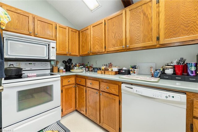 kitchen with lofted ceiling and white appliances