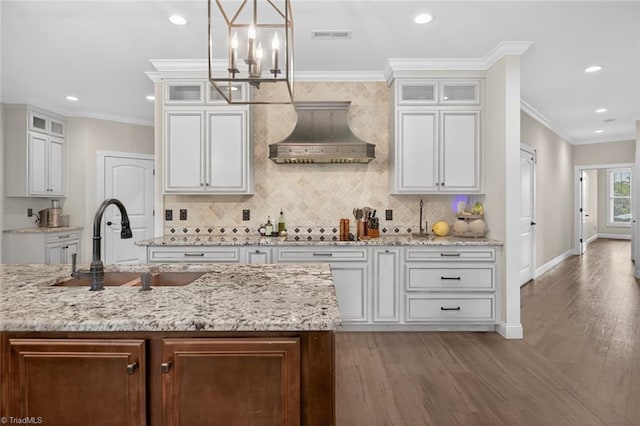 2643 NC Highway 801, Mocksville, NC 27028 - kitchen featuring wall chimney range hood, a chandelier, recessed lighting, light wood finished floors, and tasteful backsplash