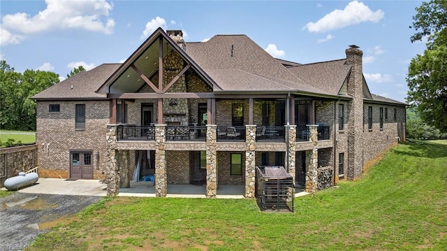 2643 NC Highway 801, Mocksville, NC 27028 - back of property featuring a patio area, a chimney, brick siding, a lawn, and a balcony
