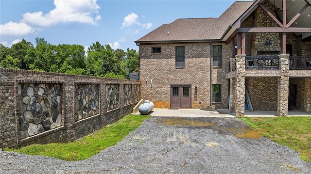 2643 NC Highway 801, Mocksville, NC 27028 - rear view of property with brick siding, a balcony, a patio, french doors, and a shingled roof