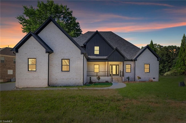 back house at dusk with a yard and cooling unit