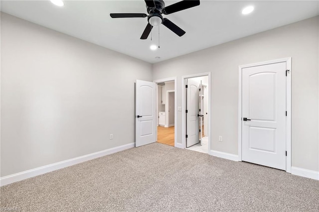 unfurnished bedroom featuring light colored carpet, baseboards, ensuite bathroom, and recessed lighting