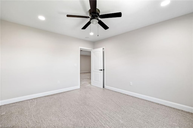 unfurnished room featuring light carpet and ceiling fan